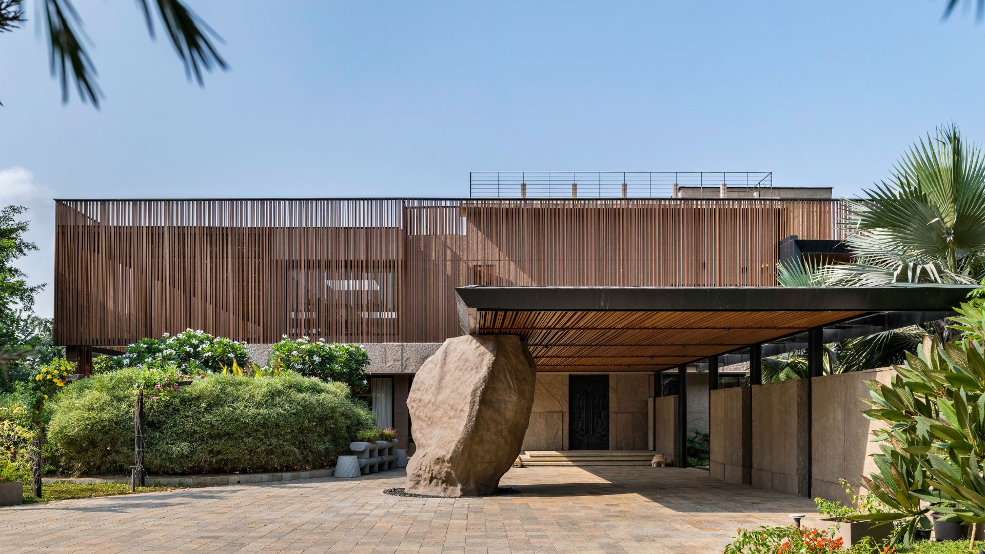 Entrance to the home is demarcated by a monumental rock; Photography by PHX India; Styling by Bonnie & Saks