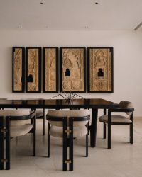 The dining table is a custom design from Escape by Creatomy, the chairs are from Magari, fabrics from Home Stories, wall sculpture from Kosh and artefacts from FabCuro; Styling by Samir Wadekar, Photography by Ishita Sitwala