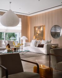 Osvaldo Gonzalez’s artwork on the wall adds a layer of depth and intrigue. Below it is a sofa by Flexform with a lamp titled Lampampe by Ingo Maurer adjacent to it. A centre table by B&B Italia is crowned by De Padova’s majestic ceiling light; Photography by Ishita Sitwala
