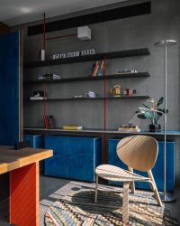 A casual seating area in the principal cabin is set against a grey backdrop of metal frames. The accessories include a Cube Light from Smart Light, an SS Lamp and Oak Chair from IKEA and Lego artefacts; Photography by Ishita Sitwala
