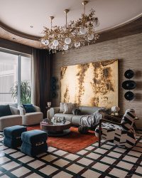 The brass panel behind the sofa, the wooden cabinetry and the exotic stone bar back in the dining area show how different materials can take centre stage when thoughtfully applied; Photography by Ishita Sitwala
